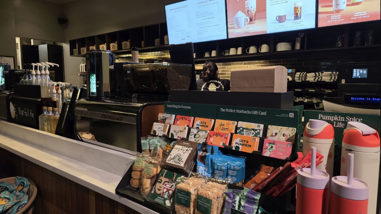 Coffee-shop counter, cups, and illuminated menus